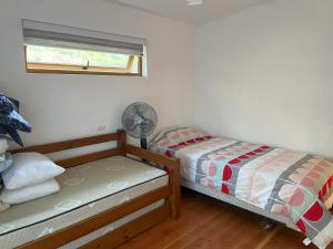 Ένα ή περισσότερα κρεβάτια σε δωμάτιο στο Cabaña Maicolpue Rio Sur