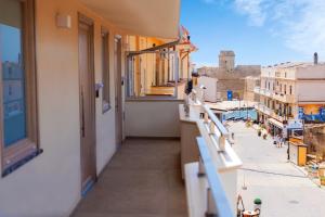 a balcony of a building with a view of a city at Art Boutique Rooms in Le Castella