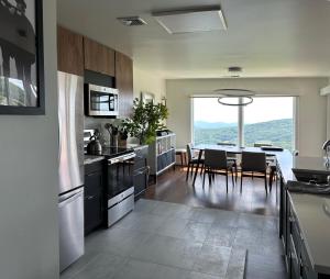 a kitchen and dining room with a table and chairs at Panoramic Ski Slope Views, private sauna, dogs ok in Wintergreen