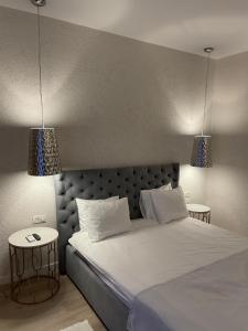 a bedroom with a large white bed with two lamps at Elia Vama Veche (Adults Only) in Vama Veche +60 photos