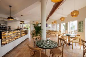 a restaurant with tables and chairs and a counter at Vale Do Lobo Resort in Vale do Lobo