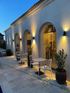 a patio with tables and chairs in a building at Elia Vama Veche (Adults Only) in Vama Veche