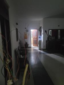 a room with a hallway with a door and a living room at Araliya in Wattala
