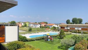 an apartment with a pool and a playground at Mazzarona Family Apartment - Luminoso appartamento con piscina al secondo piano in Sirmione