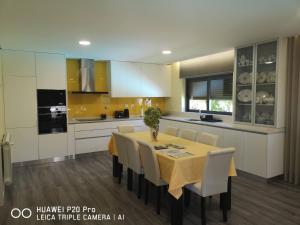 eine Küche mit Esstisch und Stühlen in der Unterkunft Casa Valente in Ponte da Barca