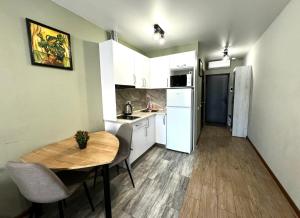 a small kitchen with a table and a refrigerator at New apartments, center, Smart TV in Kharkiv