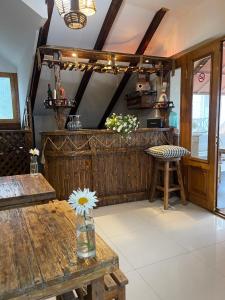 a room with a wooden counter and a table with a flower on it at Betlemi Old Town Hotel in Tbilisi City