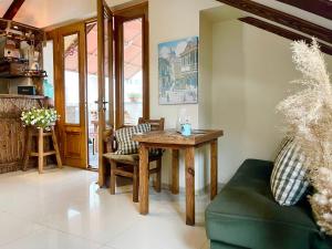 a living room with a wooden table and a green couch at Betlemi Old Town Hotel in Tbilisi City