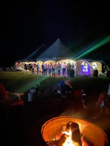 a group of people standing in front of tents at night at Graham Inn in New Glasgow +61 photos