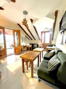 a living room with a green couch and a table at Betlemi Old Town Hotel in Tbilisi City