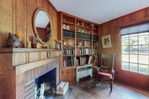 a living room with a fireplace and a mirror at Fieldcrest in Brevard