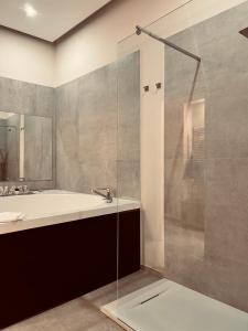 a bathroom with a tub and a sink and a shower at Mael Superior Room in Palermo