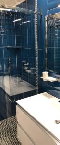 a bathroom with a sink and a glass shower at B&B Carpe Diem Domus in Lacco Ameno