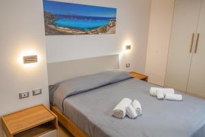 Postel nebo postele na pokoji v ubytování Isgrò Rooms
