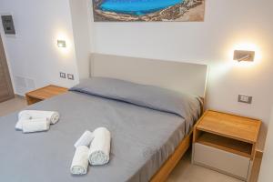 Postel nebo postele na pokoji v ubytování Isgrò Rooms