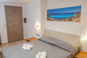 Postel nebo postele na pokoji v ubytování Isgrò Rooms
