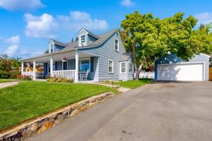 a large blue house with a driveway at Farmhouse Minus the Farm in East Wenatchee