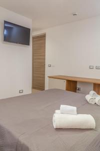 Postel nebo postele na pokoji v ubytování Isgrò Rooms