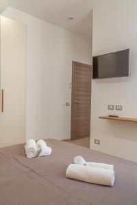 Postel nebo postele na pokoji v ubytování Isgrò Rooms
