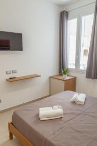 Postel nebo postele na pokoji v ubytování Isgrò Rooms