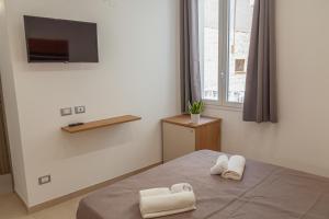 Postel nebo postele na pokoji v ubytování Isgrò Rooms