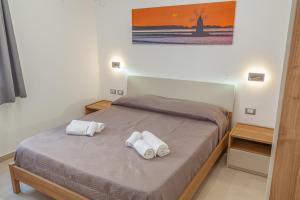 Postel nebo postele na pokoji v ubytování Isgrò Rooms