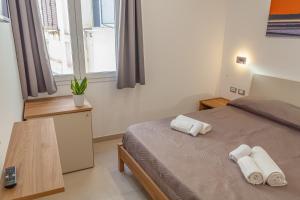 Postel nebo postele na pokoji v ubytování Isgrò Rooms