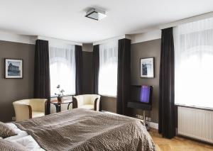 Łóżko lub łóżka w pokoju w obiekcie Hotel Borg by Keahotels