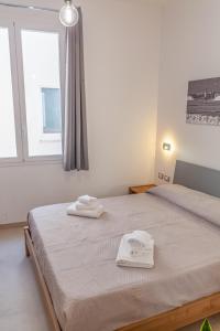 Postel nebo postele na pokoji v ubytování Isgrò Rooms