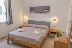 Postel nebo postele na pokoji v ubytování Isgrò Rooms