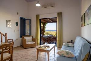 a living room with a couch and a table at Olive Garden Houses in Palekastron