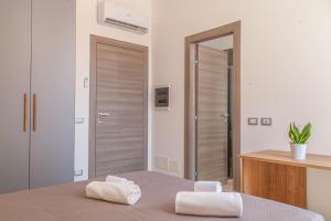 Postel nebo postele na pokoji v ubytování Isgrò Rooms