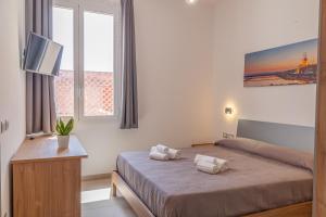 Postel nebo postele na pokoji v ubytování Isgrò Rooms