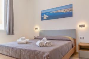 Postel nebo postele na pokoji v ubytování Isgrò Rooms