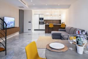 a living room with a couch and a table at Florette Suite 1BR w Stunning Lounge Terrace by Arco Collection in Il-Furjana