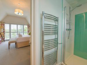 a bathroom with a shower and a bedroom at Dove Cottage in Dittisham +49 photos