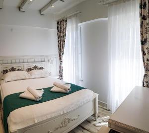 a bedroom with a bed with two pillows on it at Bozcaada Fresh Otel in Canakkale