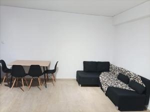 a living room with a couch and a table at Euphemia's Apartment in Ampavris