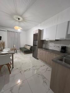 a kitchen with a table and a couch in a room at Ammoudia Summer House in Skiathos