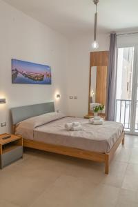 Postel nebo postele na pokoji v ubytování Isgrò Rooms