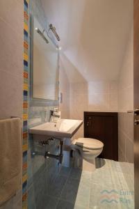 a bathroom with a sink and a toilet at Casa Eira de Arriba - by entreRías in Cangas de Morrazo +25 photos
