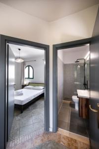 a bedroom with a bed and a bathroom with a sink at AMMOS FAMILY APARTMENTS in Vasiliki +33 photos