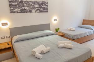 Postel nebo postele na pokoji v ubytování Isgrò Rooms