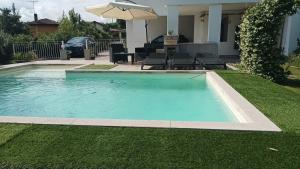 a swimming pool in the middle of a yard at Margot Ca Bianca Dormelletto Lago Maggiore in Dormelletto