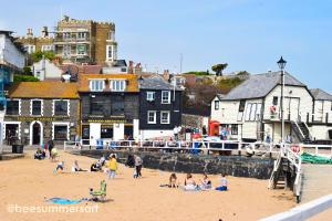 a group of people on a beach near a harbor at Family Seaside Bungalow - Max 6 Adults Only in Margate