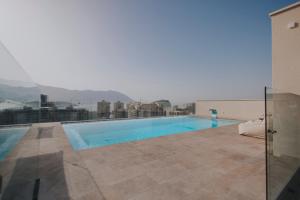 a swimming pool on the roof of a building at Infinity Hotel & More in Budva