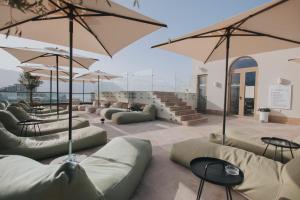 a seating area with couches and umbrellas at Infinity Hotel & More in Budva