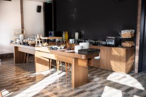 a kitchen with a counter with wooden tables at Infinity Hotel & More in Budva