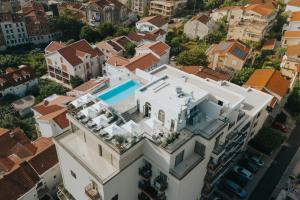 an aerial view of a house with a swimming pool at Infinity Hotel & More in Budva