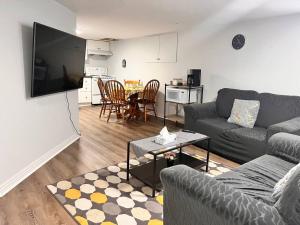 a living room with a couch and a table at Cozy basement 2 bedroom 2 bath with parking in Richmond Hill